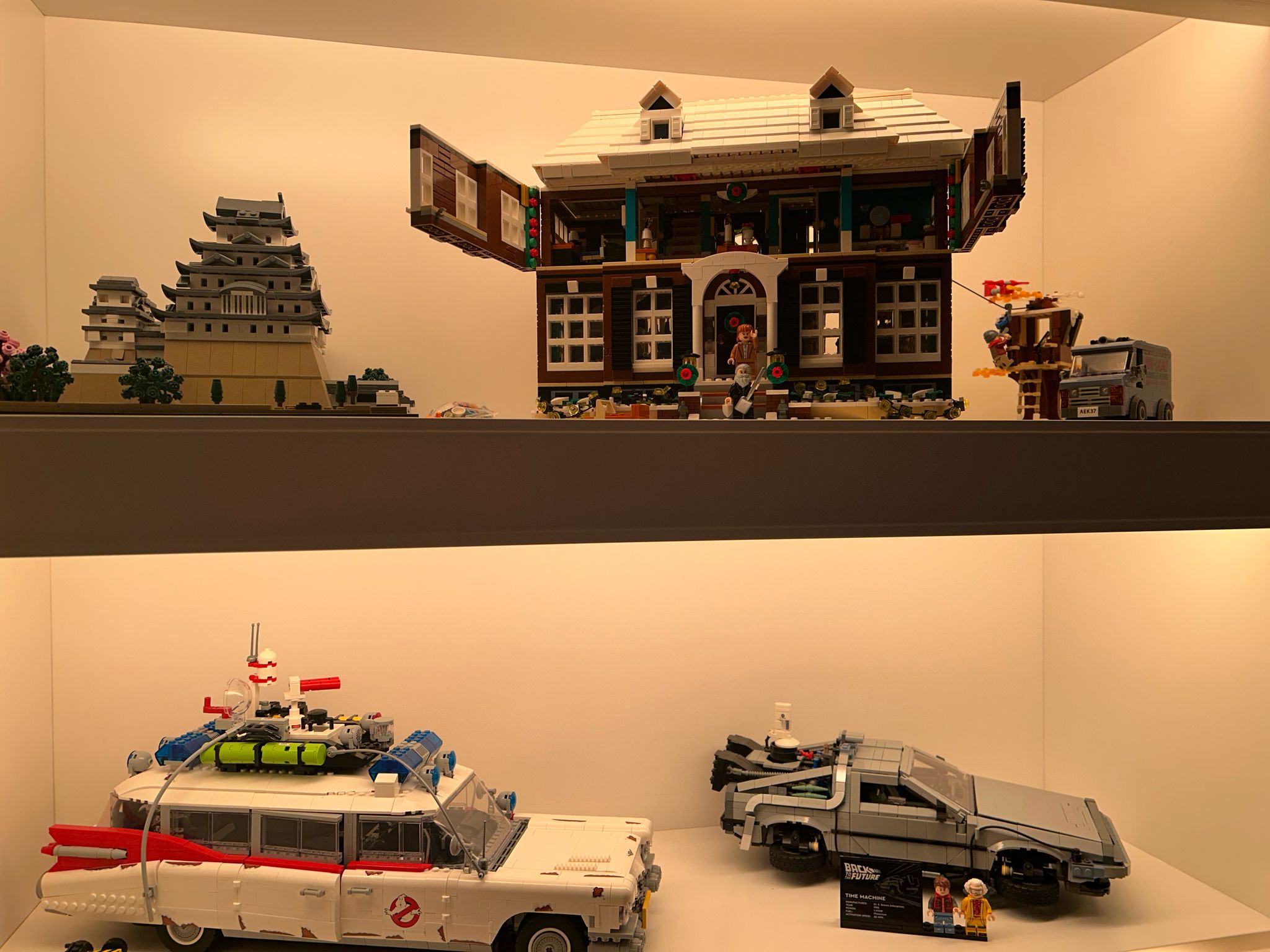 Vitrina iluminada con la colección LEGO: castillo japonés, casa de Solo en Casa, Ecto-1 y DeLorean